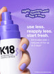 Hand holding airwash dry shampoo spraying product with text surrounding it.